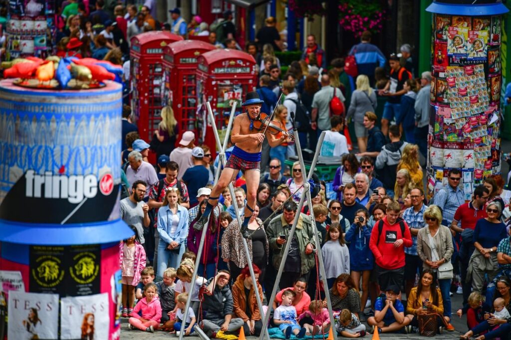 Colorful chaos in the Main Square with street performances at Edinburgh Fringe Festival